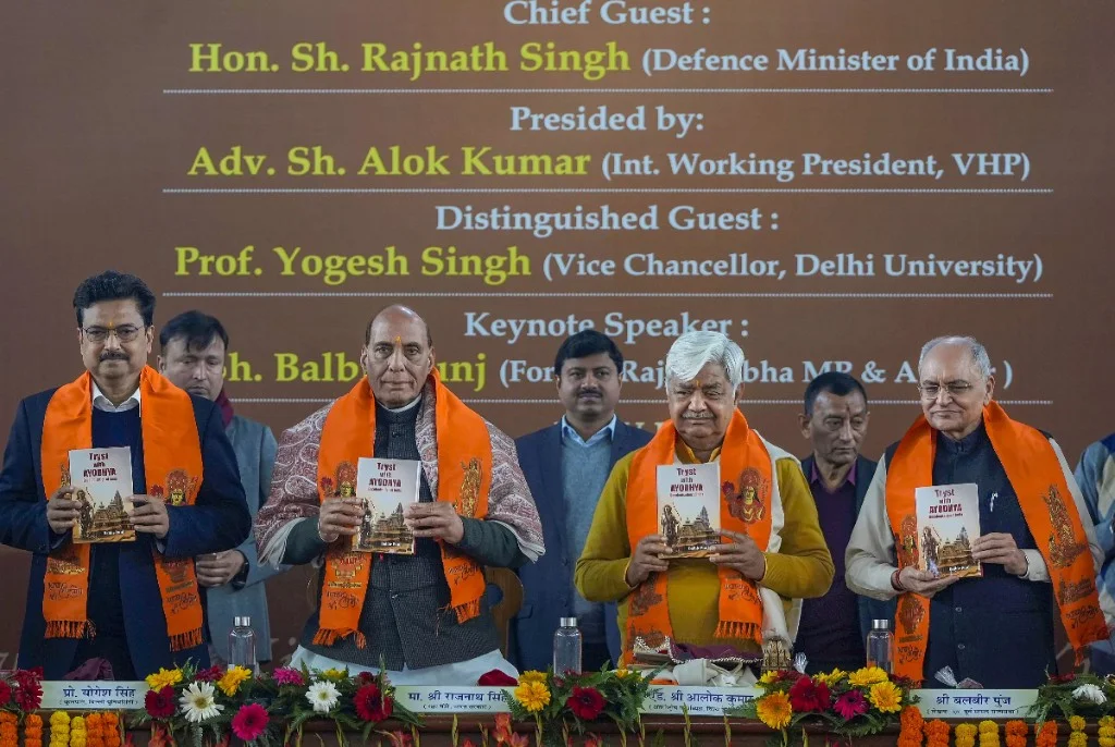 Guests holding books at a Delhi University launch event